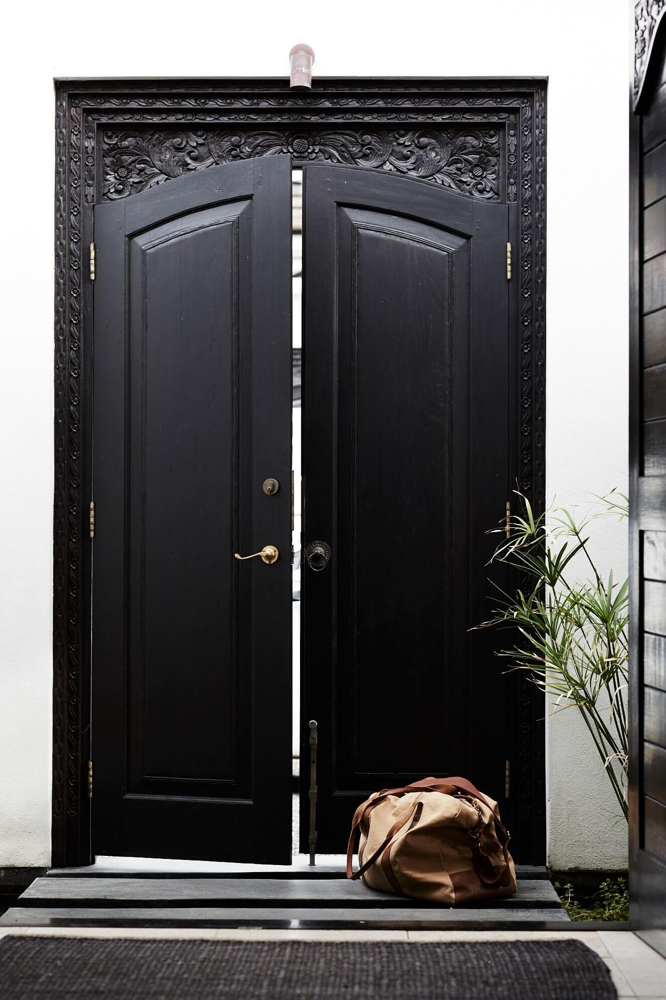 Vintage carved timber entry doors to The Villas of Byron