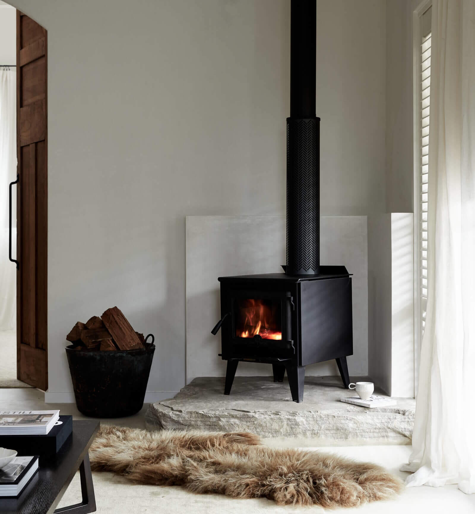 Le Viti Barn Newrybar: Indoor fireplace set on a stone hearth