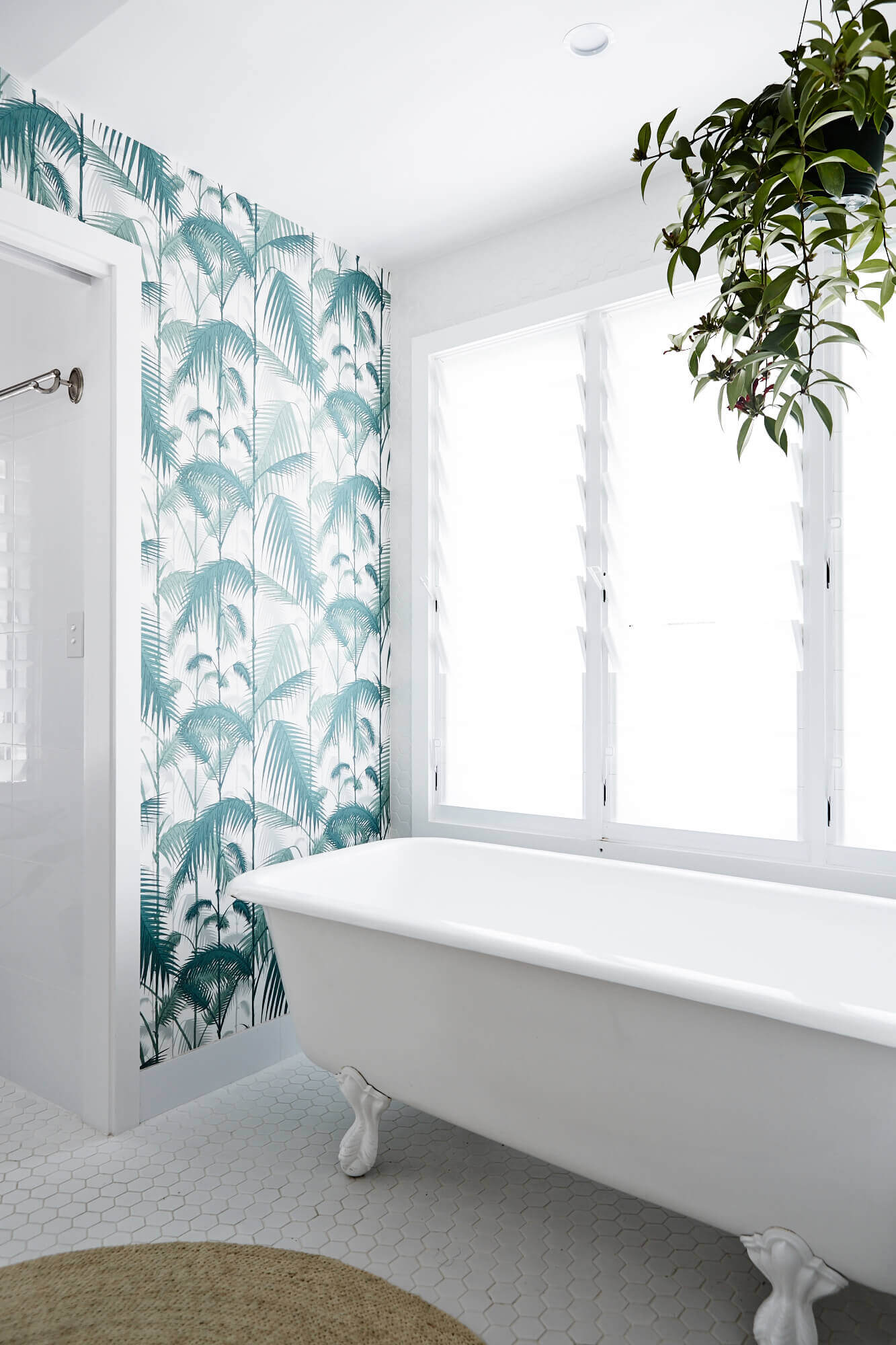 Master ensuite at Magnolia House, Byron Beach Abodes with up-cycled claw foot vintage bath and tropical patterned wallpaper