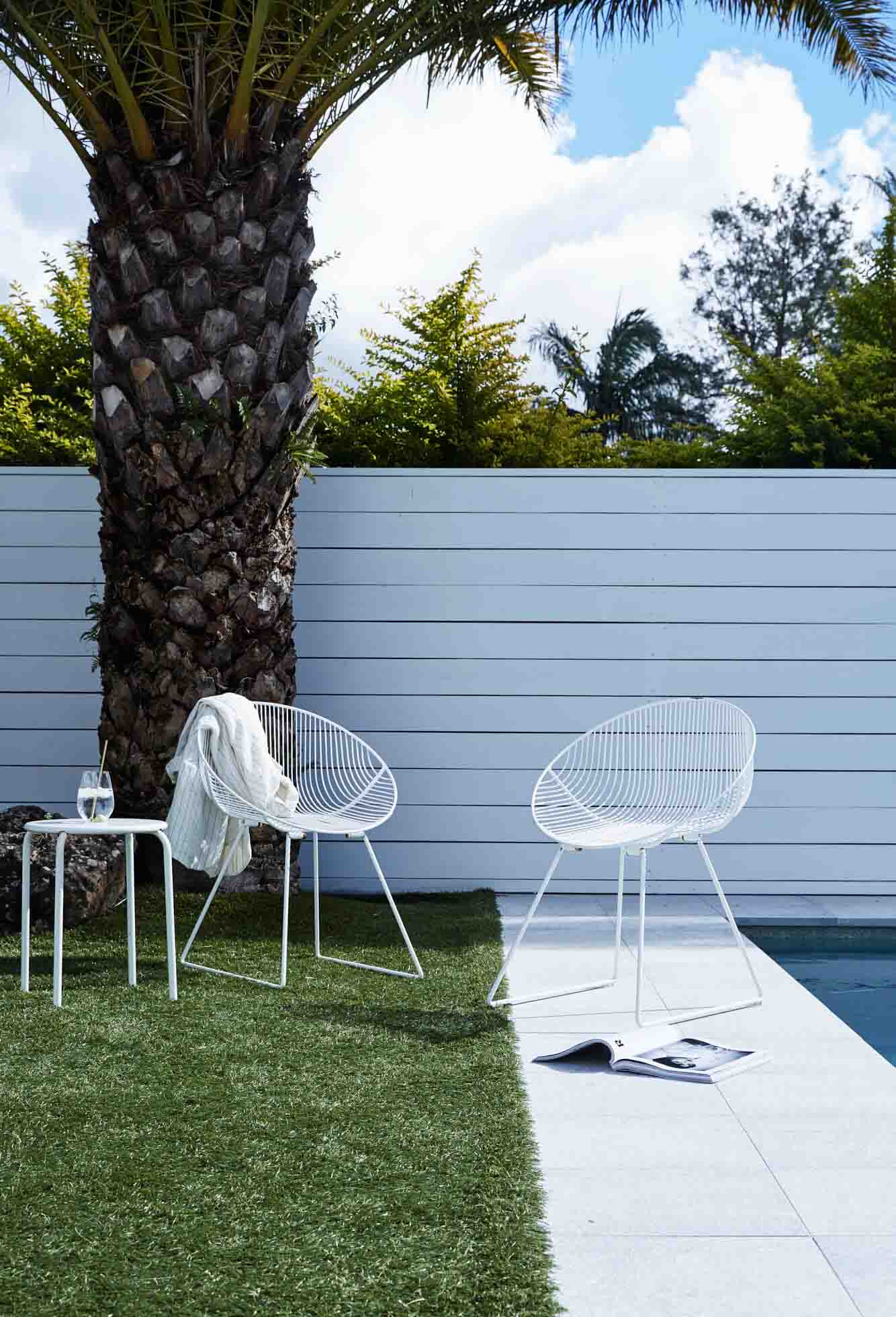 Outdoor seating by the pool at The Chalet, Byron Beach Abodes