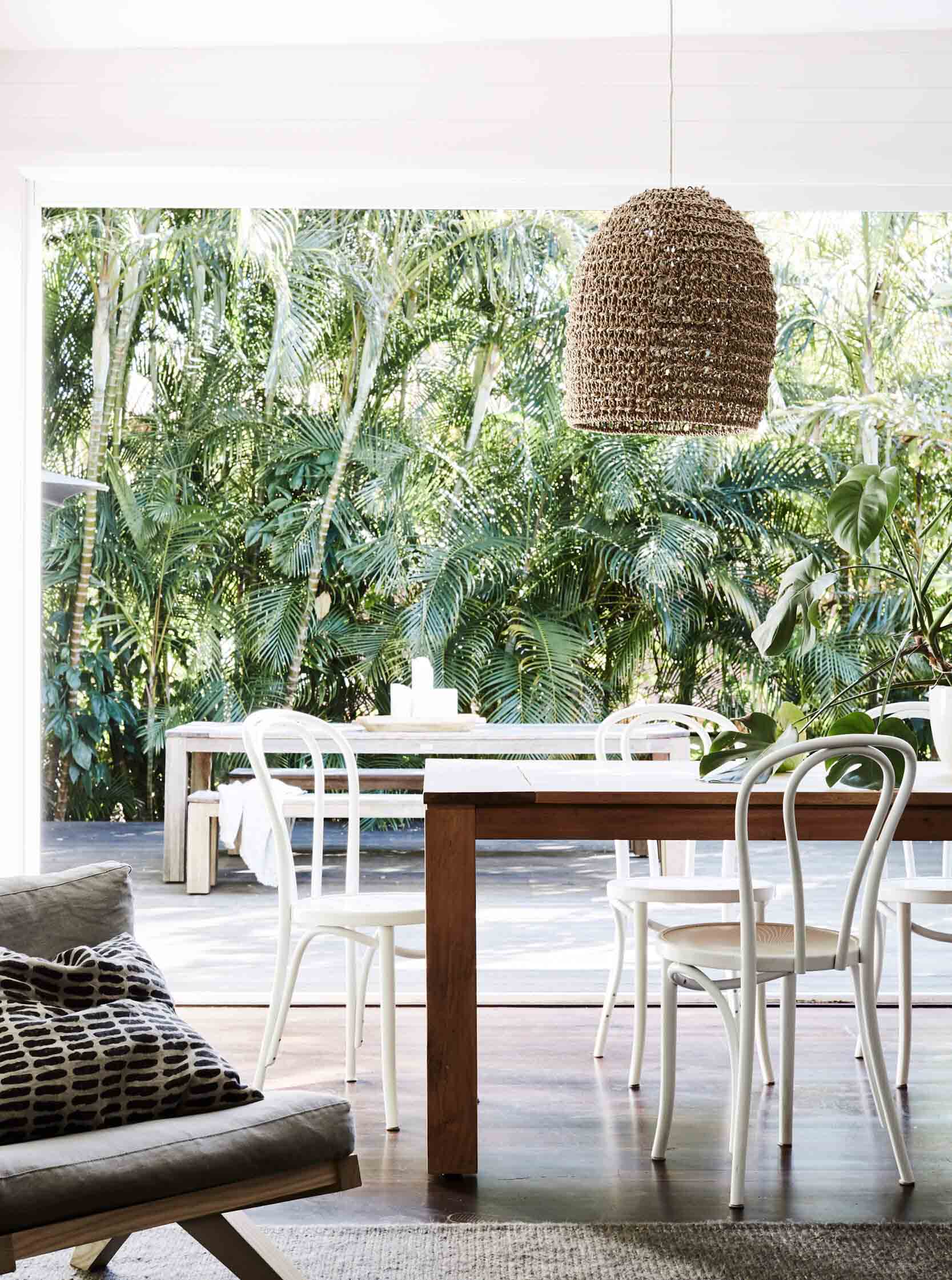 Open plan dining room at The Cottage, The Bower Byron Bay looking out to the private tropical gardens and outdoor dining area
