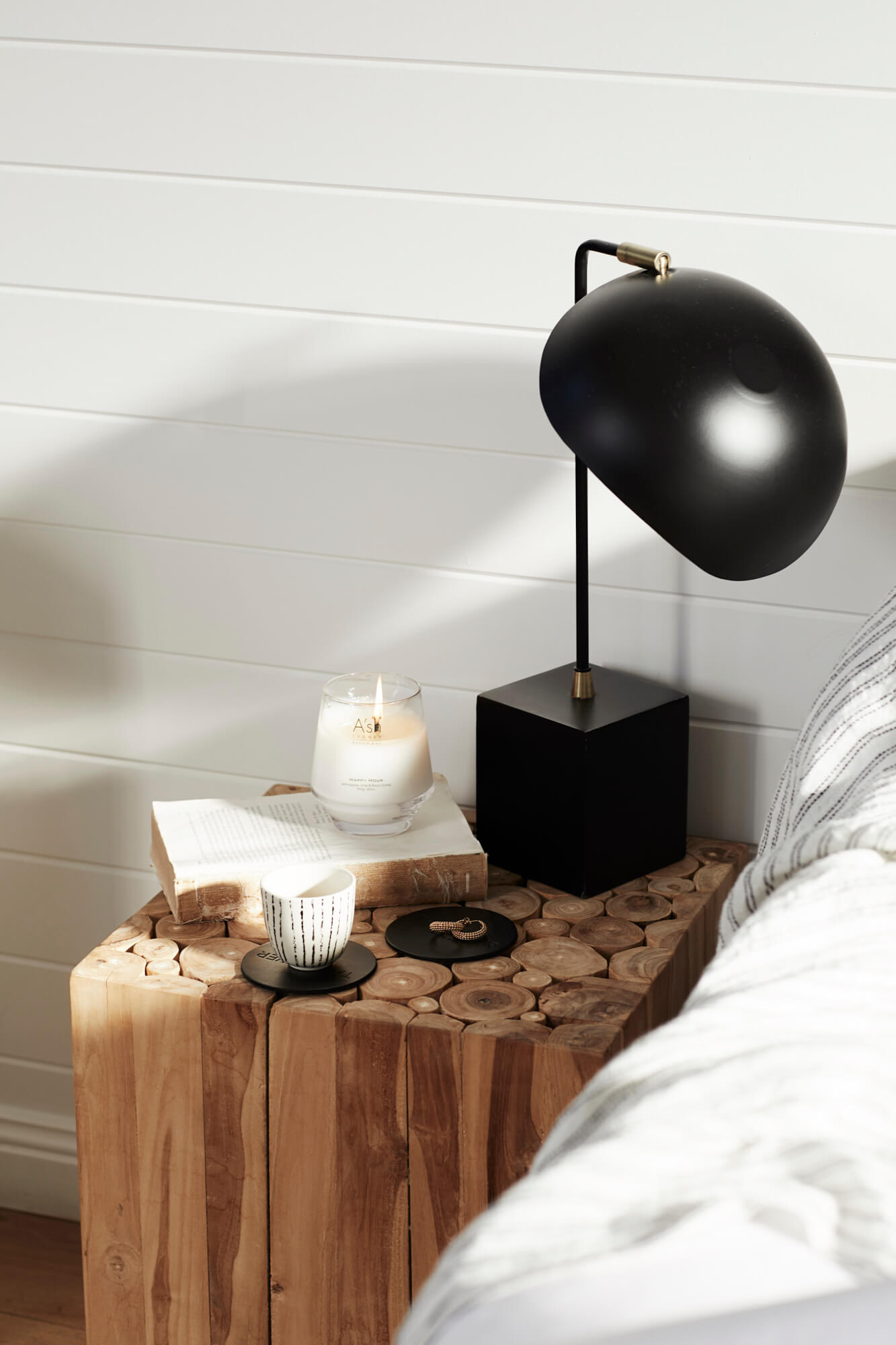 Round black lamp on timber bedside table at the Bower Barn, The Bower Byron Bay hotel