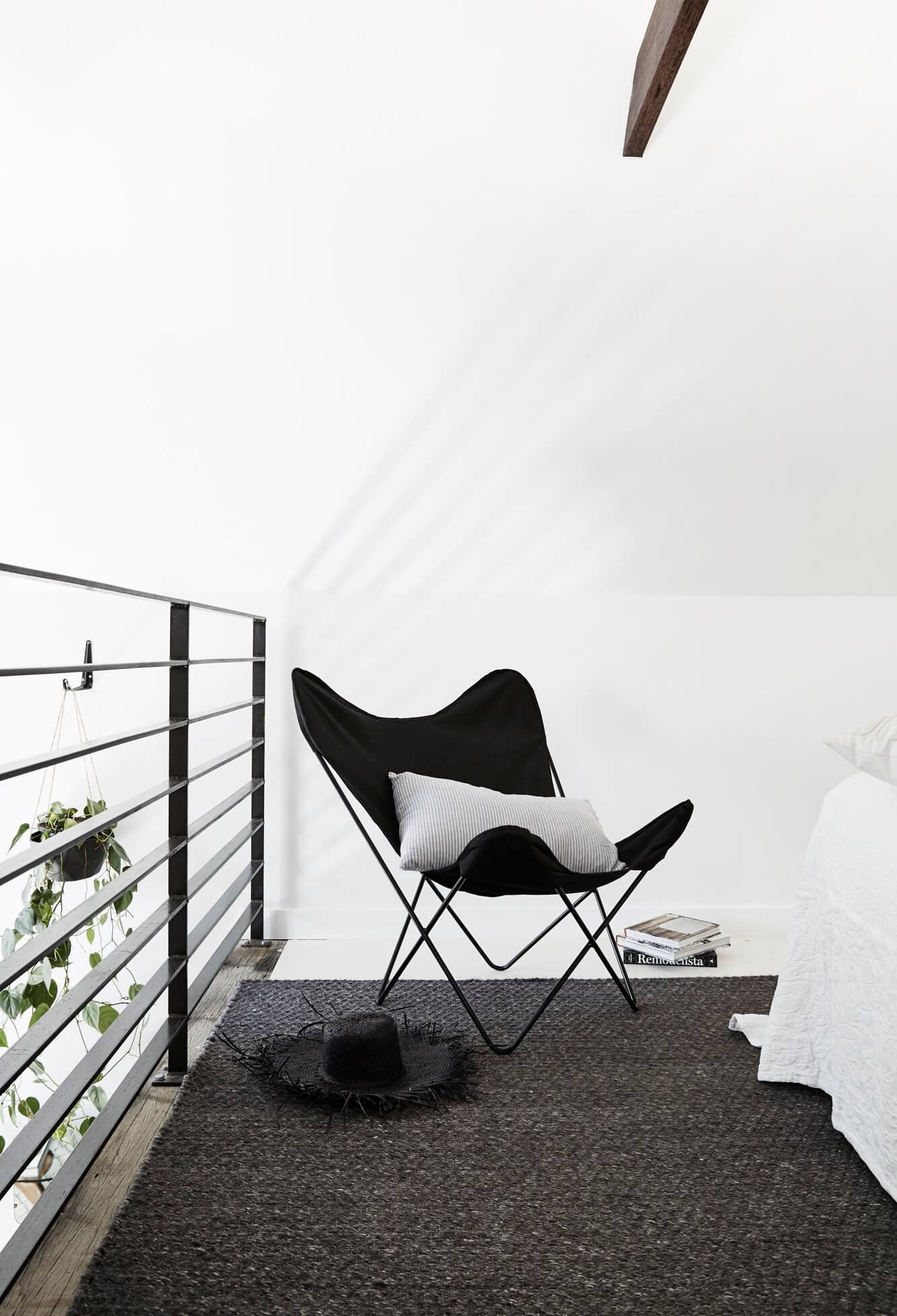 Black butterfly chair in bedroom at The Chapel, Byron Beach Abodes