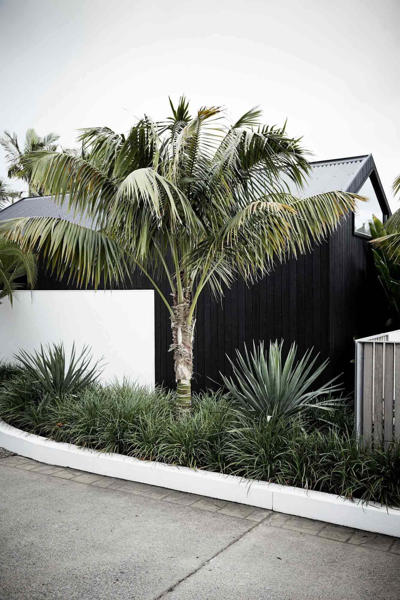Black and white exterior of the private Bower Studios at The Bower Byron Bay hotel